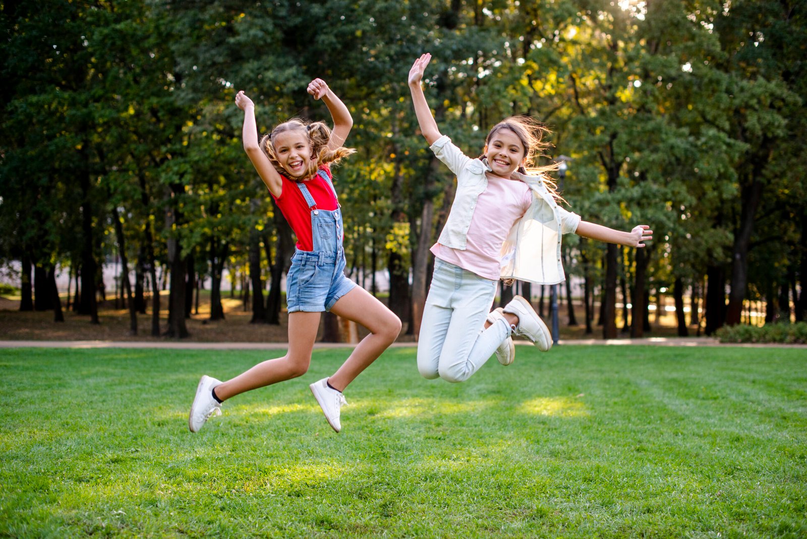 front-view-girls-jumping-park